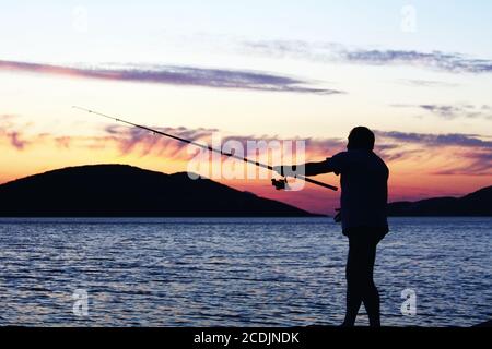 Angeln bei Sonnenuntergang Stockfoto