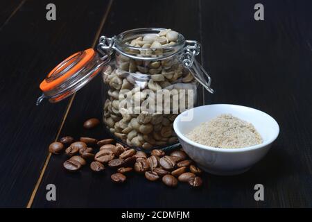 Grüner Kaffee im Glas, ungegeröstetes Kaffeepulver in einer Schüssel und geröstete Kaffeebohnen, Deutschland Stockfoto