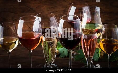 Weinverkostungskonzept, Stillweine und Schaumweine. Rot, Weißwein, Rose und Champagner in Weingläsern auf Vintage Holztisch Hintergrund Stockfoto