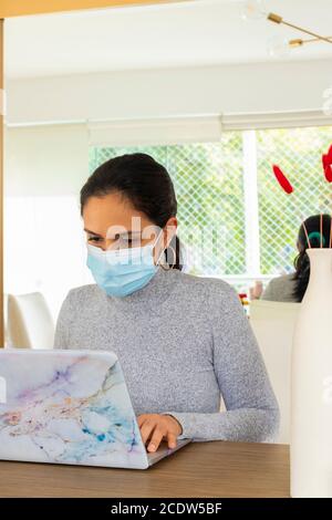 Schöne lateinische Frau, die Home Office für den Corona-Virus Pandemie Stockfoto