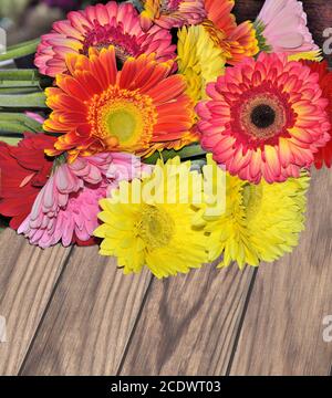 Bouquet von verschiedenen bunten Gerberas Nahaufnahme auf einem hölzernen Hintergrund Stockfoto