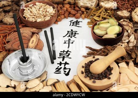 Chinesische Kräutermedizin mit Kräutern, Gewürzen & Kalligraphie Schrift mit Moxa-Sticks für Moxibustion. Übersetzung liest sich als chinesische Kräuter für gute Gesundheit. Stockfoto