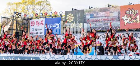 Team japanischer yosakoi-Kindertänzer auf der Bühne beim Tanz mit Naruko, Holzklatschern, während des Kumamoto Kyusyu Gassai Tanzfestivals in Japan Stockfoto