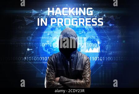 Gesichtsloser Hacker bei der Arbeit mit HACKING IN PROGRESS Inschrift, Computer-Sicherheitskonzept Stockfoto