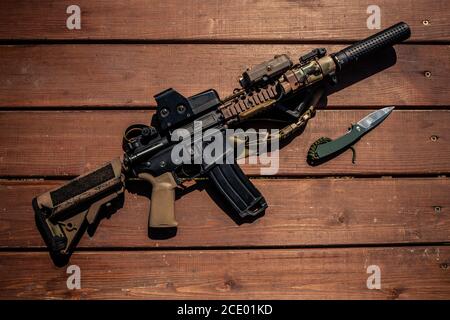 Oben Ansicht von modernen Gewehr und Messer auf Holztisch, Soldaten Waffen Konzept Stockfoto