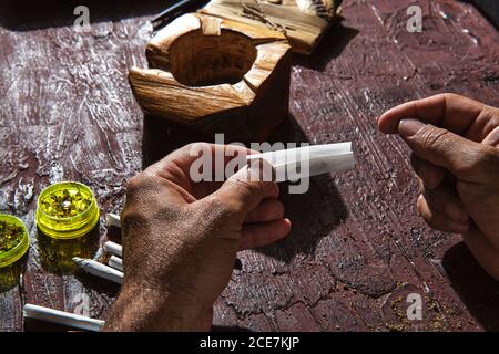 Unkenntlich männlicher Raucher, der Marihuana Joint macht Stockfoto