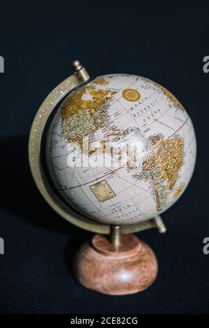 Moderner Schreibtischglobus mit kuscheligem Marmorhalter, der Nord und zeigt Südamerika auf schwarzem Hintergrund Stockfoto