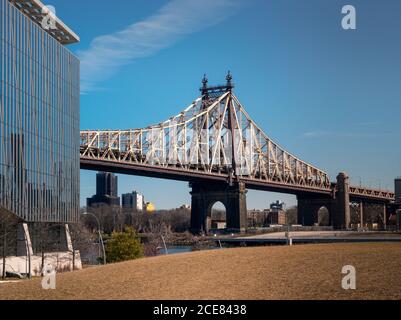 Low-Angle-Ansicht der Queensboro Bridge überqueren Fluss gegen blau Himmel am sonnigen Frühlingstag in New York City Stockfoto