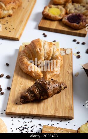 Nahaufnahme des Frühstückstisches mit verschiedenen Croissants und Kaffee Bohnen Stockfoto