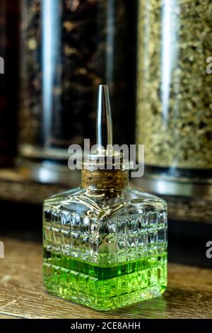 Glasflasche aus grünem Absinth mit Spender auf der Theke platziert Im Retro-Pub Stockfoto