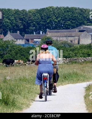 Kaukasisches Paar mit dem Fahrrad auf dem Tissington Trail, Peak District National Park, Derbyshire, England, Großbritannien im Juni Stockfoto