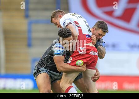 Joe Burgess (5) von Wigan Warriors wird von Derrell angegangen Olpherts (2) von Castleford Tigers und Alex Foster (17) von Castleford Tigers Stockfoto