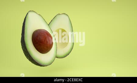 Avocado halbiert auf grünem Hintergrund. Stockfoto