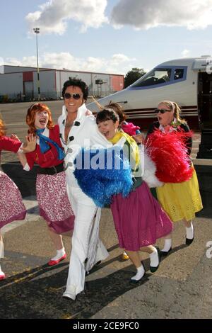 Glasgow Prestwick Airport Ayrshire im Vereinigten Königreich ist der einzige Ort, der von 'The King of Rock & Roll Elvis Presley. Auf nationaler Dienst Sargent Presley wurde von kreischenden Fans am 3. März 1960 begrüßt, nachdem sein Flugzeug gestoppt, um aufzutanken : Foto zeigt Elvis Presley ( aka Gordon Hendricks Gewinner der ITV Stars in Their Eyes 2005 ) Ankunft am Flughafen Glasgow Prestwick als der Flughafen sich als "Pure Dead Brilliant" umbennant der Flughafen wurde vor kurzem von Infratil Limited, einem in Neuseeland ansässigen Infrastrukturinvestitionsunternehmen, übernommen Stockfoto