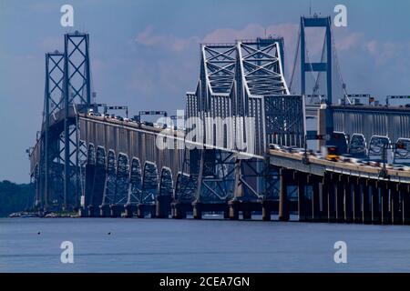 Tageszeit-Teleaufnahme mit Langzeitbelichtung, die den Verkehr auf der Chesapeake Bay Bridge zeigt. Es verfügt über eine detaillierte Ansicht der Brücke mit Säulen und Stockfoto