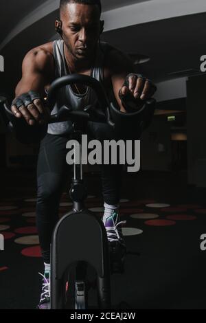 Serious schwarzen Mann auf Heimtrainer im Fitnessstudio Stockfoto
