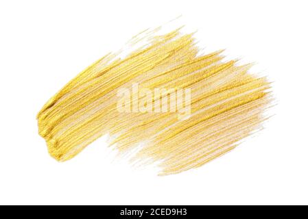 Pinselstrich aus goldenem Acryl auf weißem Hintergrund. Stockfoto