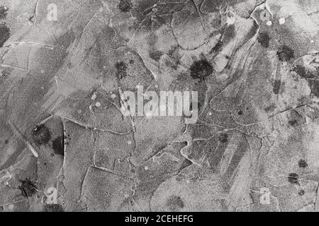 Graue abstrakte Hintergrundtextur mit Putzflecken und Spritzern. Schwarz und Weiß Stockfoto