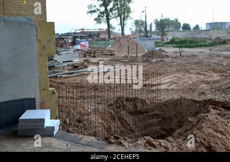 Сonstruction der Bewehrung für die Schalung auf dem Fundament für die nächste Betonierung der Veranda am Mehrfamilienhaus. Mineralwolldämmung o Stockfoto