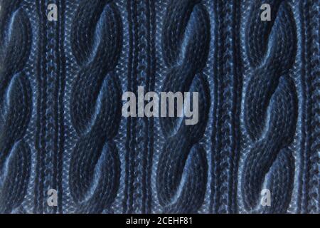 Pullover oder Schal Textur große Strick. Gestrickter Jersey-Hintergrund mit Reliefmuster. Zöpfe im Stricken. Wolle handgestrickt oder maschinell stricken pa Stockfoto
