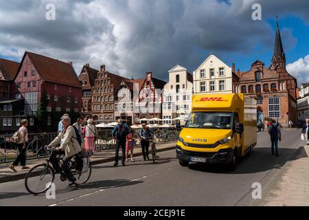 Die Altstadt von Lüneburg, Stintmarkt am Fluss Ilmenau, historisches Hafenviertel, viele Restaurants, Kneipen, Cafés, DHL Paketdienst Fahrzeug, Low Stockfoto