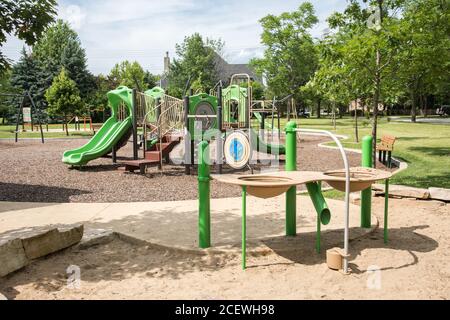 Aurora, Illinois, USA-April 19,2014: Vorstädtischer Spielplatz im Wohngebiet mit Rutschen, Schaukeln und Wassertisch in Aurora, Illinois Stockfoto