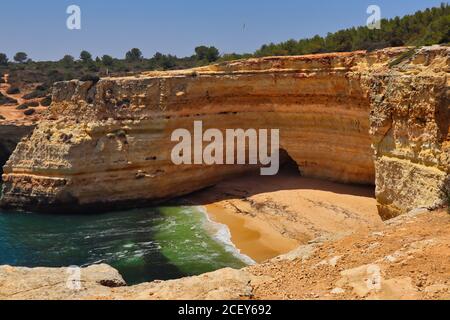 Ein Bild von einem Strand mit atlanischem Ozean und seinen Wellen, Sandsteinklippen. Schöne goldene Küste mit türkisfarbenem Wasser. Stockfoto