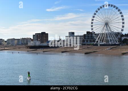 SUP Board mit einem Leine Paddel Neoprenanzug benötigt, um zu nehmen Auf dem Paddle Boarding stehen auf Surfbrett, um West Sussex zu bewundern Küste paddeln um Worthing Stockfoto