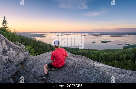 Malerische Panoramalandschaft mit See, Sonnenuntergang und Kindern am Abend in Koli, Nationalpark, Finnland Stockfoto