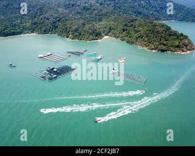 Fischerboote bewegen sich in der Nähe der Fischerfarm bei Teluk Bahang. Stockfoto