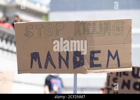 Ein selbstgebautes Pappschild mit der Aufschrift "Stoppen Sie den Mandem" bei einem Protest der Black Lives Matter auf dem Trafalgar Square in London Stockfoto