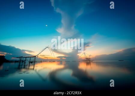 Landschaftsbild von traditionellen quadratischen Fischnetz Ausrüstung bei Sonnenaufgang in Pakpra Kanal, Phatthalung, Thailand Stockfoto