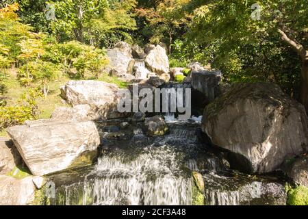 Der Mini-Wasserfall im japanischen Garten von Kyoto in Holland Park, Holland Park Avenue, Kensington, London, W11, Großbritannien Stockfoto