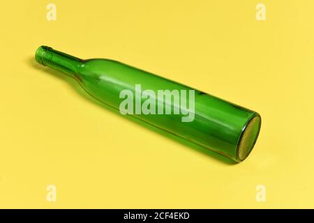 Grüne Glasflasche auf gelbem Hintergrund Stockfoto