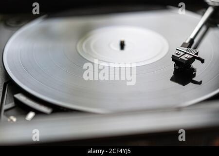 Eine schwarze Vinyl-Platte dreht sich auf einer Vintage-Platte Player Stockfoto