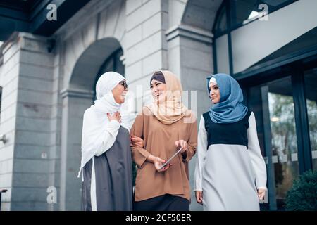 Drei Muslimische Freundinnen, Die In Der Stadt Spazieren Stockfoto