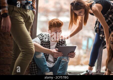Gruppe von Freunden mit Handys - Studenten sitzen in einer Reihe und tippen auf dem Smartphone Stockfoto