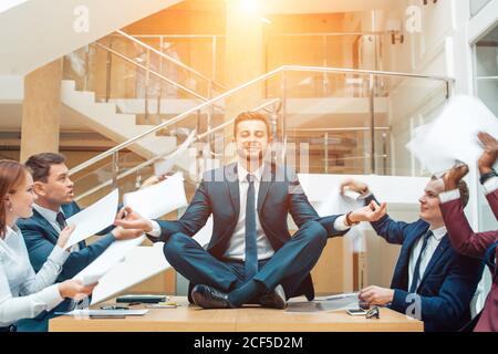 Geschäftsverhandlungen, männliche Partner streiten, lustig unbeschwerten Mann ruhig in Stress-Situation, meditieren mit komponierten Lächeln, Umgang mit emo Stockfoto