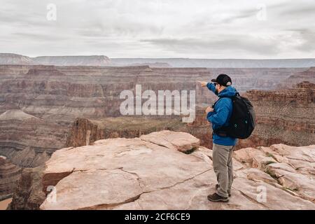 Rückansicht des Mannes mit Rucksack bewundern malerischen Blick auf canyon in den USA Stockfoto