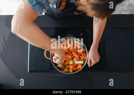 Frau kocht Gemüsesuppe in der Küche Stockfoto