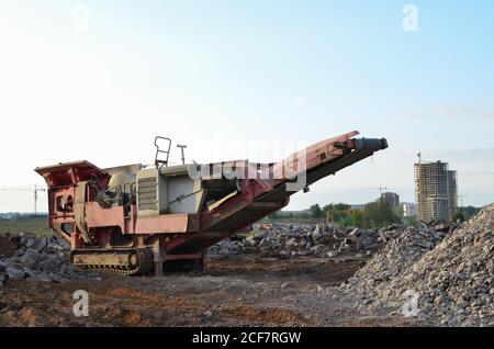 Mobile Steinkiefer-Brechmaschine zum Zerkleinern von Beton in Kies und anschließender Zementherstellung. Bergung und Recycling der Abbruchkonstruktion Stockfoto