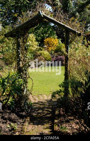 Attraktiver privater Vorstadtgarten durch Torbogen, Kent, England Stockfoto