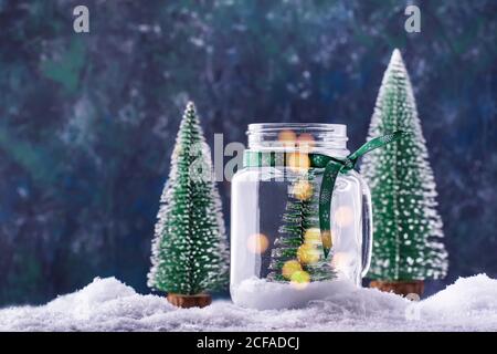 Kleiner Weihnachtsbaum in einem Glas, Silvester verschneiten Hintergrund, Weihnachtskonzept Stockfoto