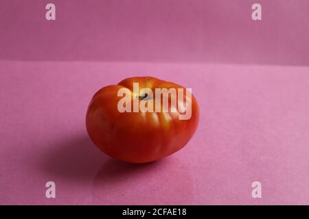 Rote große Tomate Gemüse Lebensmittel liegen auf rosa Hintergrund mit Speicherplatz kopieren Stockfoto