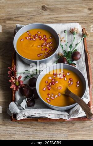 Serviert Schüsseln mit köstlicher Kürbissuppe Stockfoto
