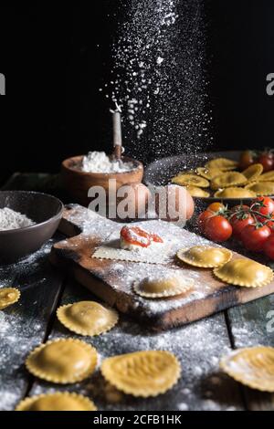 Hausgemachte Ravioli mit Parmesankäse, Tomate und Basilikum. Typisches Gericht der italienischen Küche Stockfoto