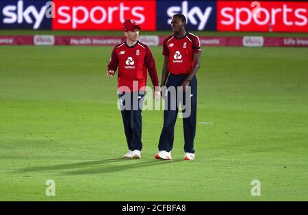 England Kapitän Eoin Morgan (links) spricht mit Jofra Archer, während er beim ersten Vitality IT20 Spiel beim Ageas Bowl in Southampton bowlt. Stockfoto