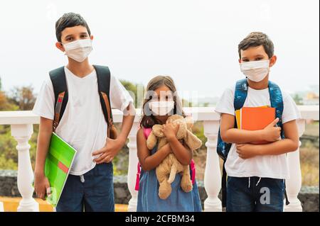 Bildung, Gesundheit und Pandemie Konzept - Gruppe von Grundschüler tragen schützende medizinische Gesichtsmasken zum Schutz vor Virus di Stockfoto