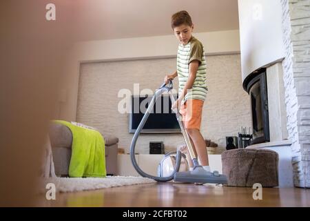 Junge Staubsaugen Boden zu Hause Stockfoto