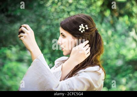 Schöne Dame, die in den Spiegel schaut Stockfoto